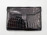 an image of a black crocodile skin wallet with a silver clasp