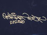 a close up of a black box with gold writing on it