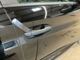 a silver car door handle with a sticker on it