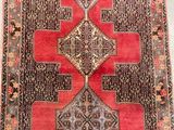 a red and black rug with a design on it
