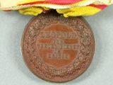 an image of a medal with a ribbon around it on a table