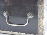 a small metal box with a handle on top of it