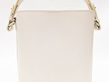 a white bucket bag with a gold handle