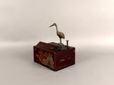 a small wooden box with a bird on top of it
