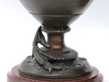 an image of a bronze vase with a snake on top of it