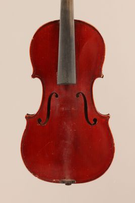 an old violin with a bow hanging from it ' s back