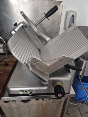 an image of a commercial meat slicer in a kitchen