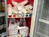 a refrigerator that has many bags of food inside of it