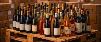 many bottles of wine sitting on a wooden pallet