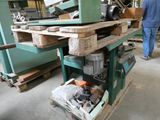 a man that is standing in front of a workbench