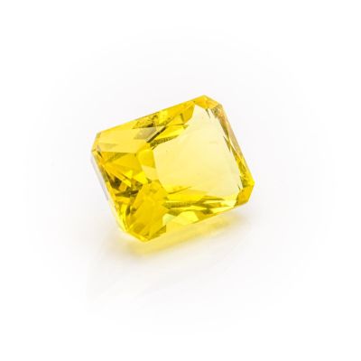 a yellow sapphire stone on a white background