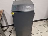 a machine that is sitting on the floor next to a chair