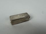 an old silver box sitting on top of a white table