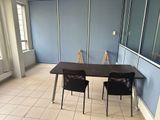a table and two chairs in a room with blue walls
