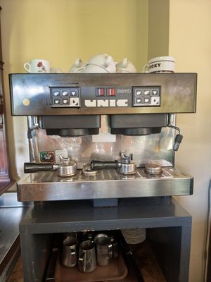 an image of a coffee machine with pots and pans on it