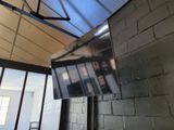 a television hanging from the ceiling in a room