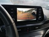 a view of a car ' s rear view mirror from the driver ' s seat