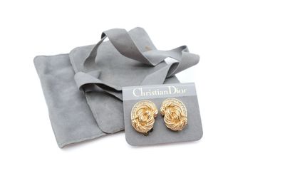 a pair of gold tone earrings with a gift bag