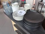 a lot of plates and bowls on the table