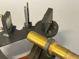 a close up of a metal device on a white surface