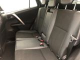 the back seats of a car with a remote control in it