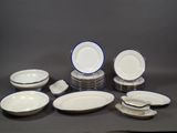 a lot of white and blue plates and bowls on the table