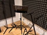 three microphone stands in front of a wall of sound foam