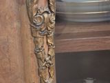 a close up of a wooden cabinet with plates on it