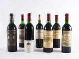 several bottles of wine are lined up on a white surface