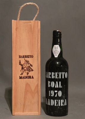 a bottle of wine that is next to a wooden box