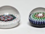 two glass balls that have different designs on them