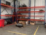 a large warehouse with lots of shelves and bins in it