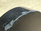 a close up of a black object with a hole in it