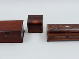three small wooden boxes and a small wooden box on a white surface