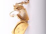 a gold locke with a keychain hanging from it ' s side