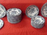 many plates that are sitting on a red cloth