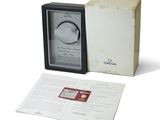 a box with a watch inside of it on a white surface