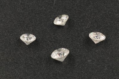 a group of five diamonds on a black surface