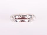a close up of a white gold wedding ring with diamonds