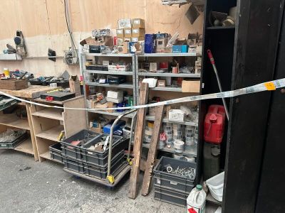 a picture of a garage with a bunch of tools on the shelves