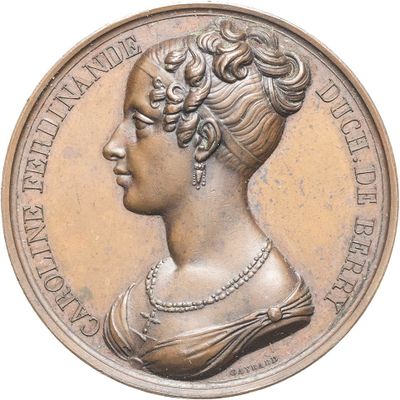 l'image d'une médaille de bronze sur laquelle figure le profil d'une femme