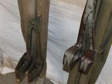 two pairs of old tools that are hanging on a pole