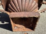 a shell shaped object sitting on the ground in the middle of the street