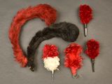 a lot of red and white feathers on a gray surface