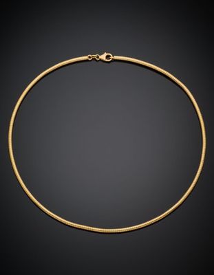 a gold necklace on a black background