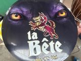 someone is holding a frisbee with a picture of a dog ' s face on it