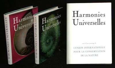 three books sitting on a table next to each other on a black surface