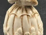 porcelain figurine of a woman in a white dress and hat