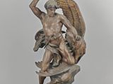 statue of a man holding a sword and a bird on a rock