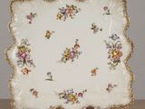a plate with flowers on it sitting on a table